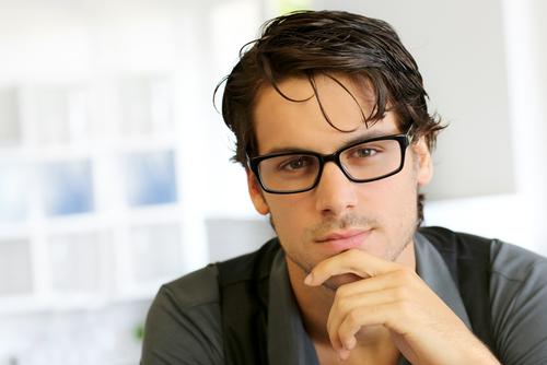 man-wearing-glasses-hand-under-chin